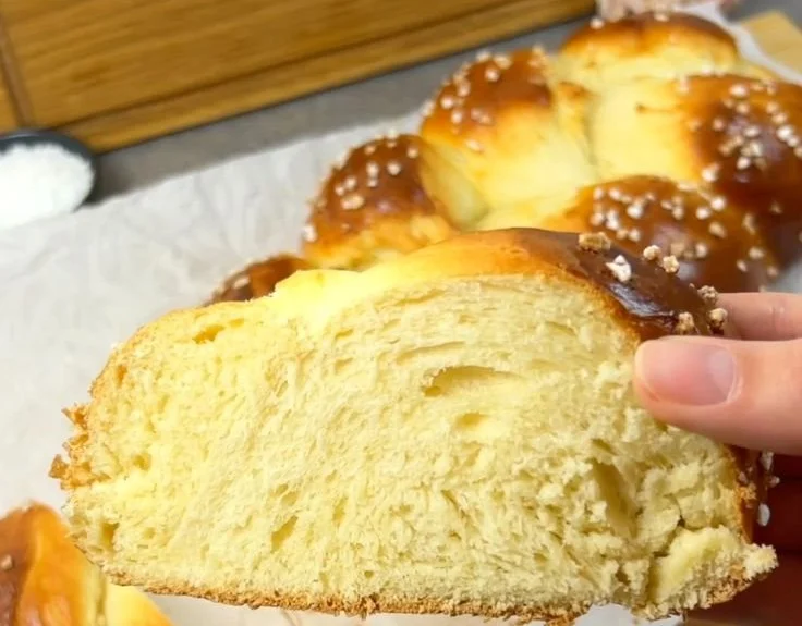 Frischer Hefezopf auf einem Holzbrett, goldbraun und appetitlich